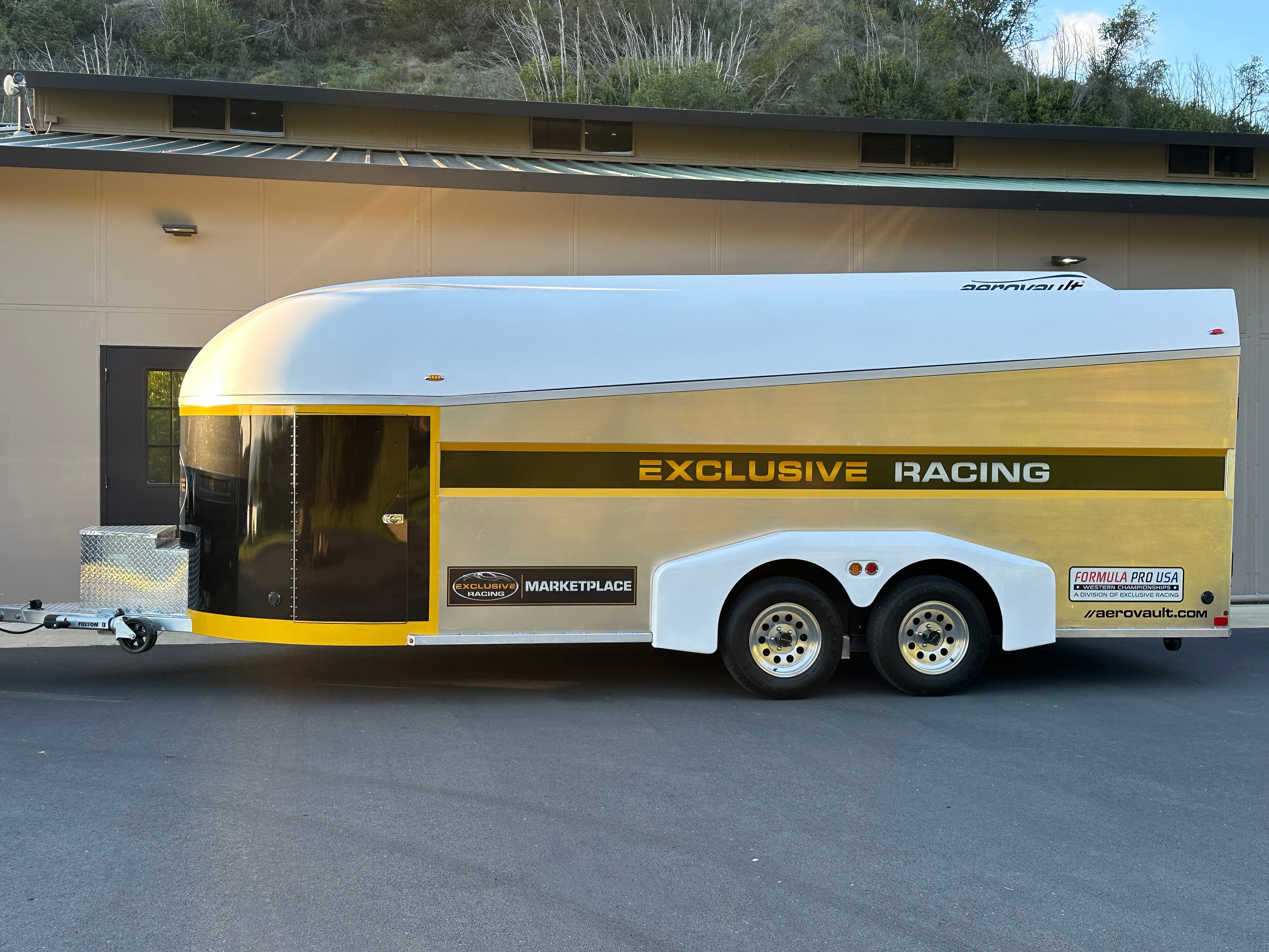 Aerovault enclosed car trailer in Exclusive Racing gold and black livery